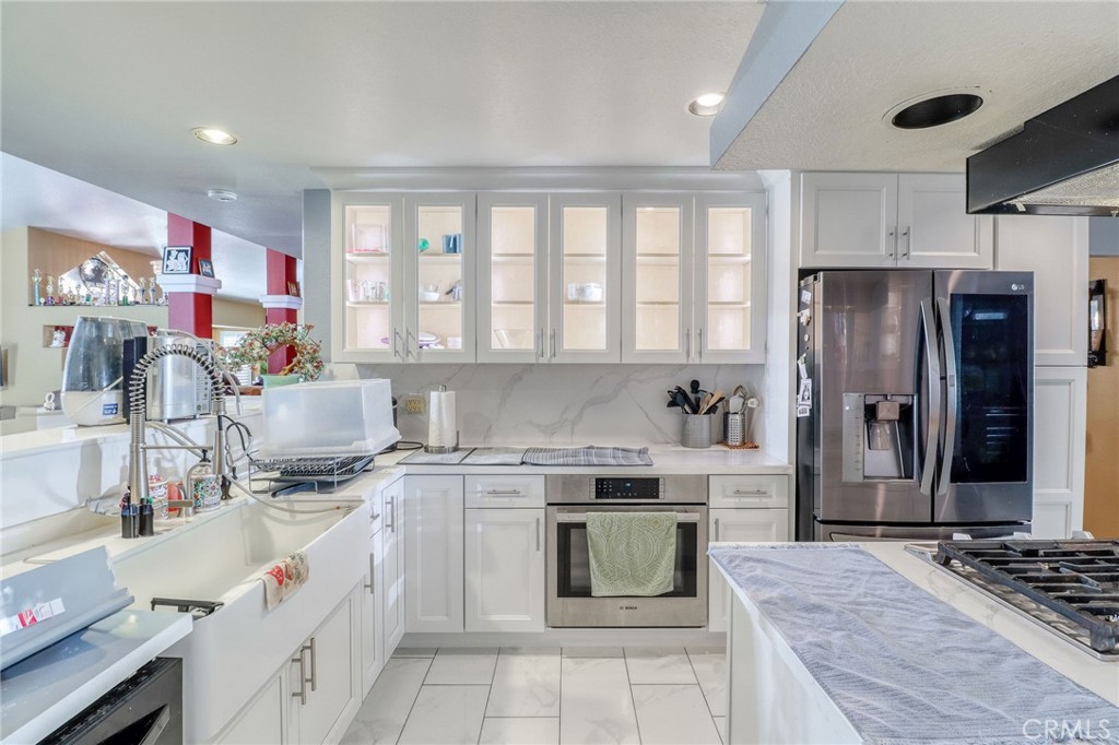 20430 Rancherias Road Apple Valley, CA 92307 - Photo 11 of 48 a kitchen that has a lot of cabinets in it and appliances
