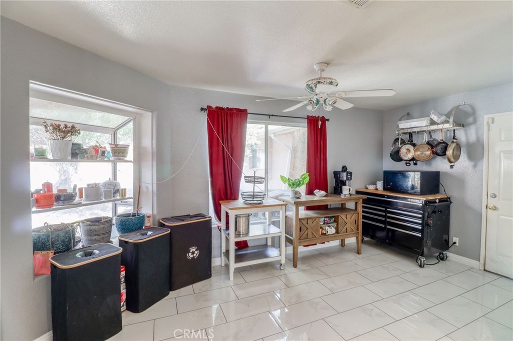 20430 Rancherias Road Apple Valley, CA 92307 - Photo 12 of 48 a living room with furniture a chandelier and a window
