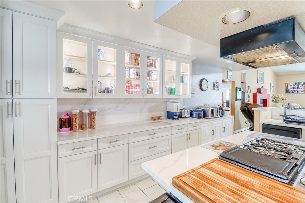 20430 Rancherias Road Apple Valley, CA 92307 - Photo 13 of 48 a kitchen with white cabinets and window