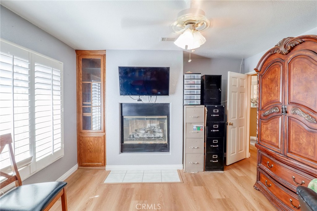 20430 Rancherias Road Apple Valley, CA 92307 - Photo 14 of 48 a view of an empty room with a fireplace and a window
