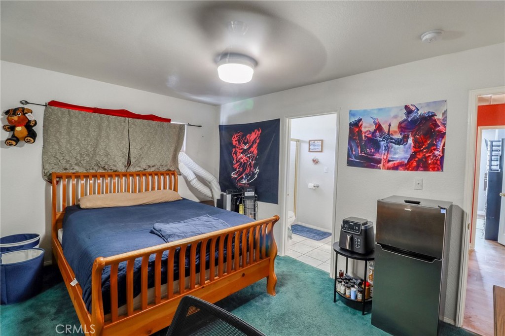 20430 Rancherias Road Apple Valley, CA 92307 - Photo 17 of 48 a bedroom with furniture and a baby crib