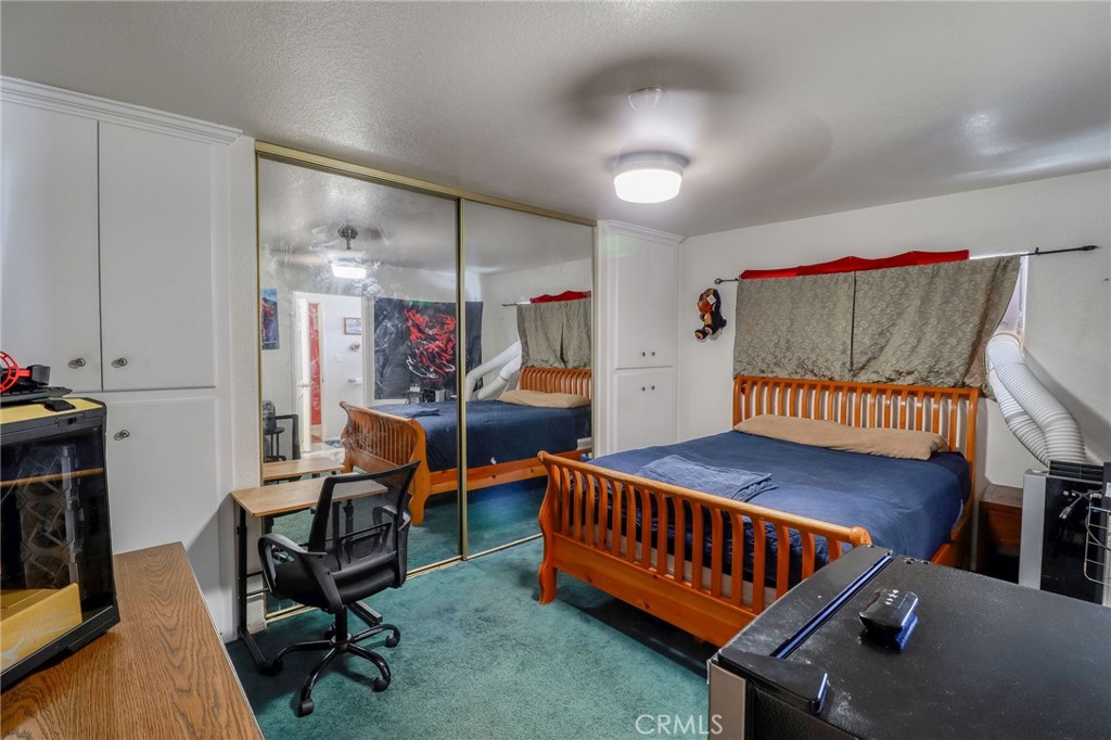 20430 Rancherias Road Apple Valley, CA 92307 - Photo 20 of 48 a bedroom with furniture and a rug