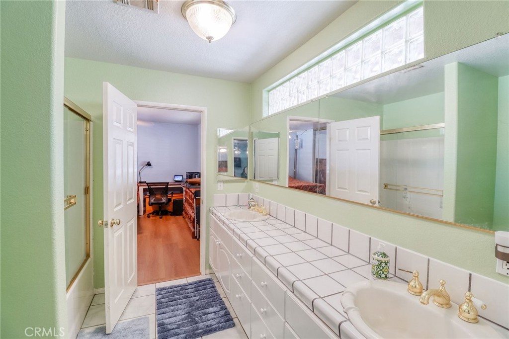20430 Rancherias Road Apple Valley, CA 92307 - Photo 22 of 48 a bathroom with a tub sink and mirror