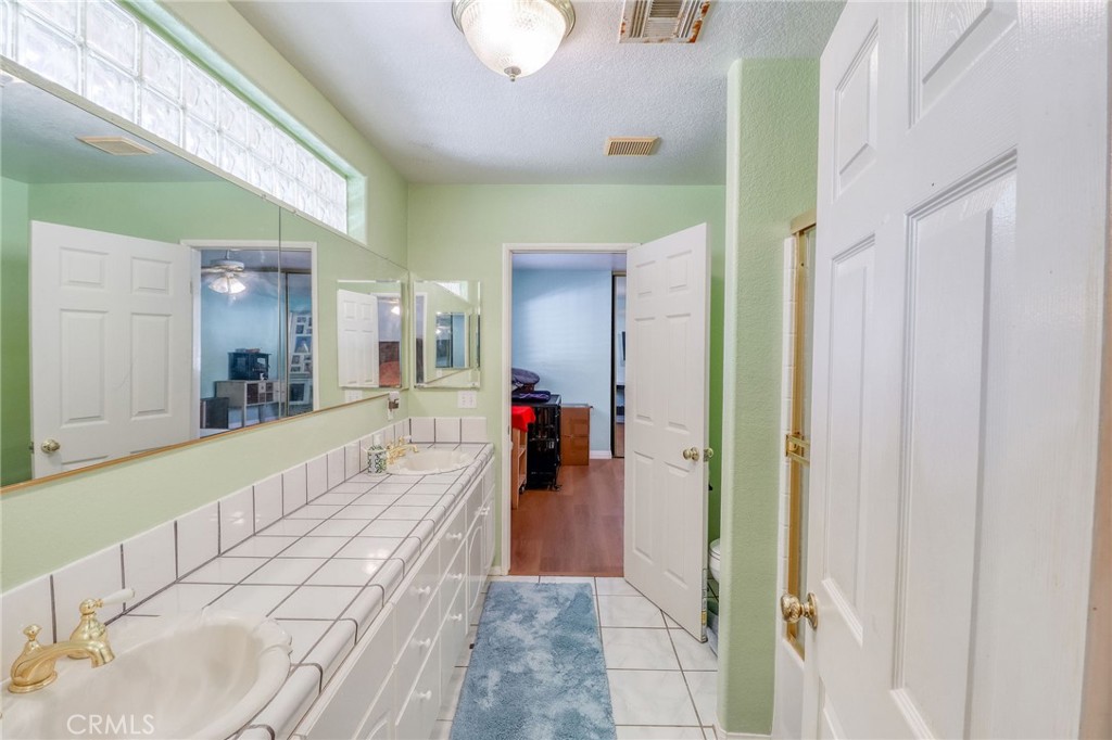 20430 Rancherias Road Apple Valley, CA 92307 - Photo 23 of 48 a bathroom with a tub and shower