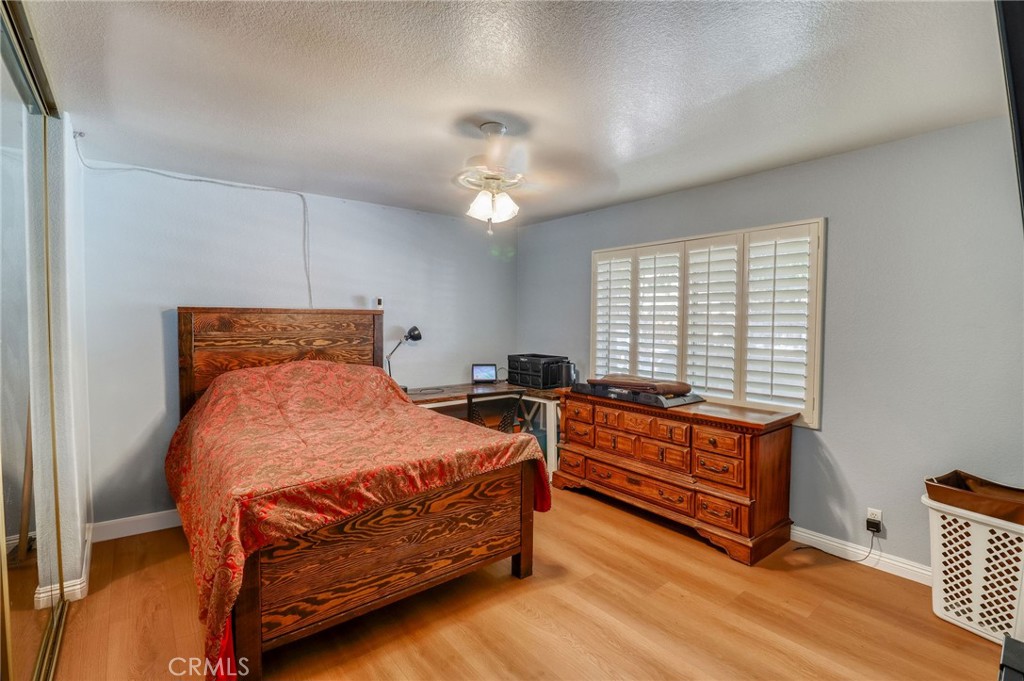 20430 Rancherias Road Apple Valley, CA 92307 - Photo 25 of 48 a bedroom with bed and window