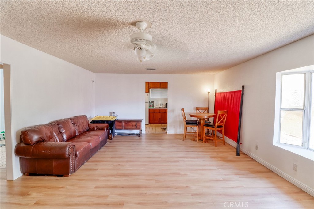 20430 Rancherias Road Apple Valley, CA 92307 - Photo 29 of 48 a living room with furniture and a wooden floor