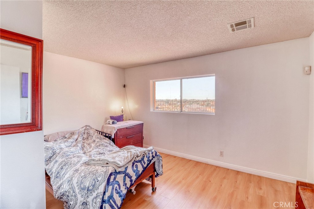 20430 Rancherias Road Apple Valley, CA 92307 - Photo 33 of 48 a bedroom with a bed and a window