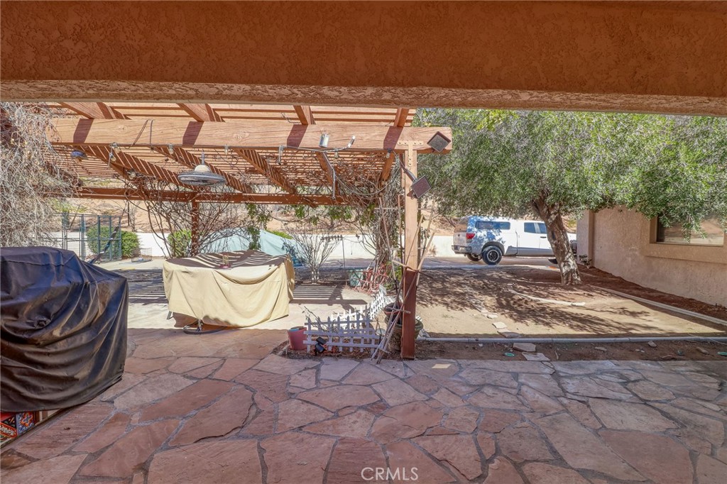 20430 Rancherias Road Apple Valley, CA 92307 - Photo 38 of 48 a view of a porch with furniture and a yard