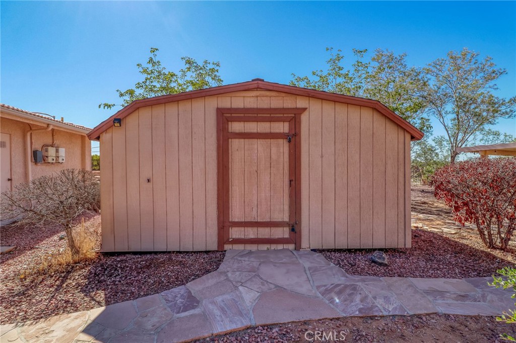 20430 Rancherias Road Apple Valley, CA 92307 - Photo 40 of 48 a view of a house with backyard and plants