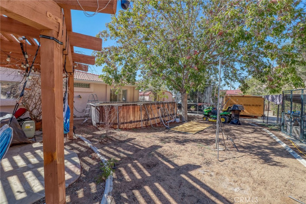 20430 Rancherias Road Apple Valley, CA 92307 - Photo 41 of 48 a view of a backyard with wooden fence