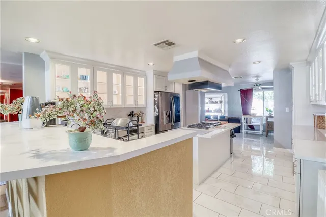a kitchen with counter top space and living room