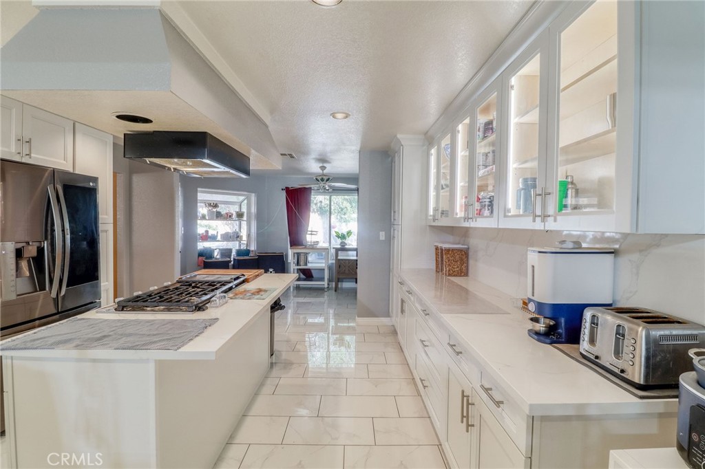 20430 Rancherias Road Apple Valley, CA 92307 - Photo 8 of 48 a kitchen with stainless steel appliances granite countertop a sink stove and refrigerator
