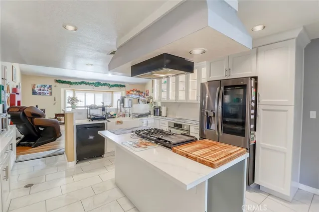 a kitchen that has a lot of cabinets in it and appliances