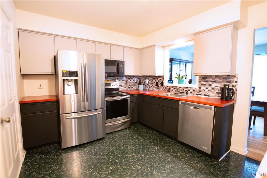 1201 Butztown Road, Unit 6 Bethlehem, PA 18017 - Photo 9 of 20 a kitchen with stainless steel appliances a refrigerator sink and cabinets
