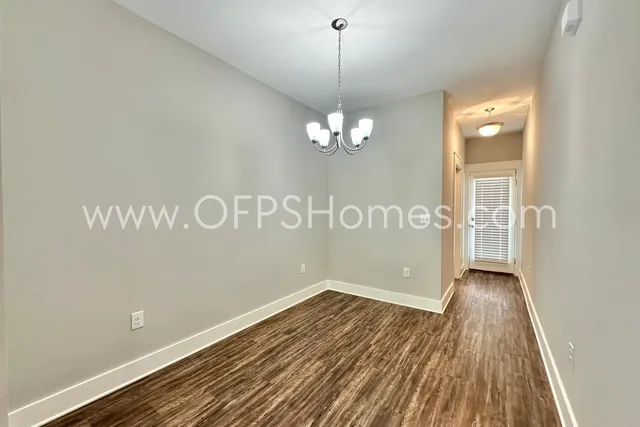 a view of wooden floor and windows in a room