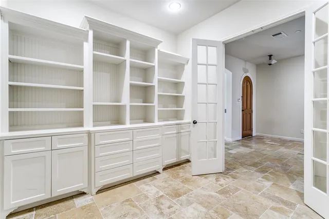 a kitchen with stainless steel appliances granite countertop a sink a stove and a refrigerator