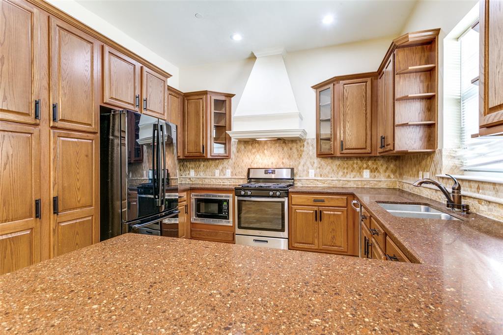 8608 Augustine Road Irving, TX 75063 - Photo 13 of 26 a kitchen with stainless steel appliances granite countertop a refrigerator sink and stove