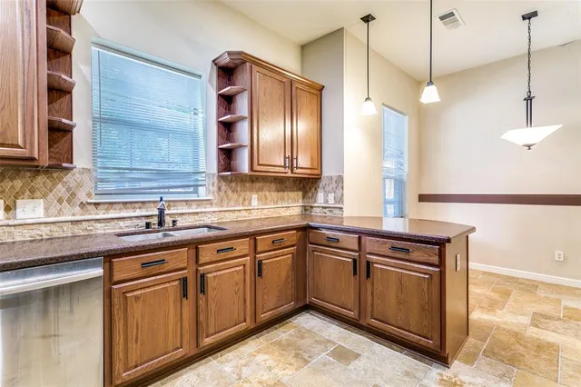 a view of an empty room with chandelier and a window