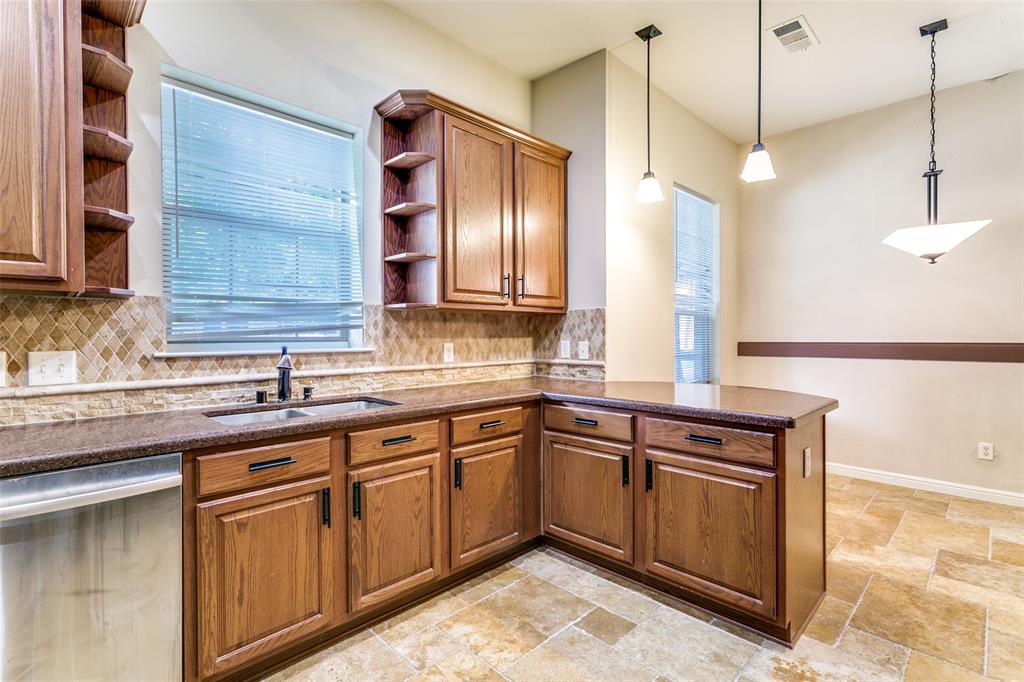 8608 Augustine Road Irving, TX 75063 - Photo 14 of 26 a kitchen with a sink and cabinets