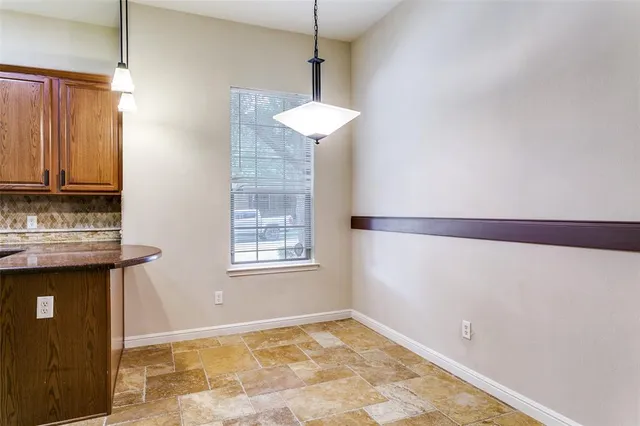 an empty room with windows and a ceiling fan