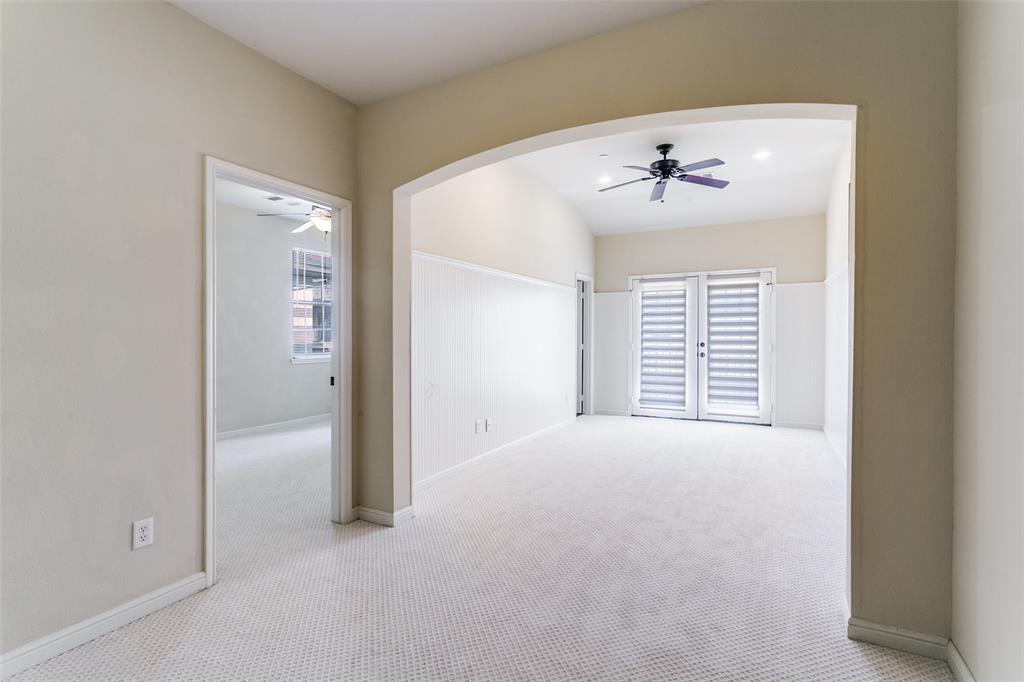 8608 Augustine Road Irving, TX 75063 - Photo 17 of 26 an empty room with windows and a ceiling fan