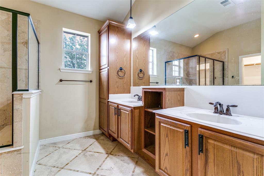 8608 Augustine Road Irving, TX 75063 - Photo 21 of 26 a view of a kitchen with a sink a refrigerator and wooden cabinets
