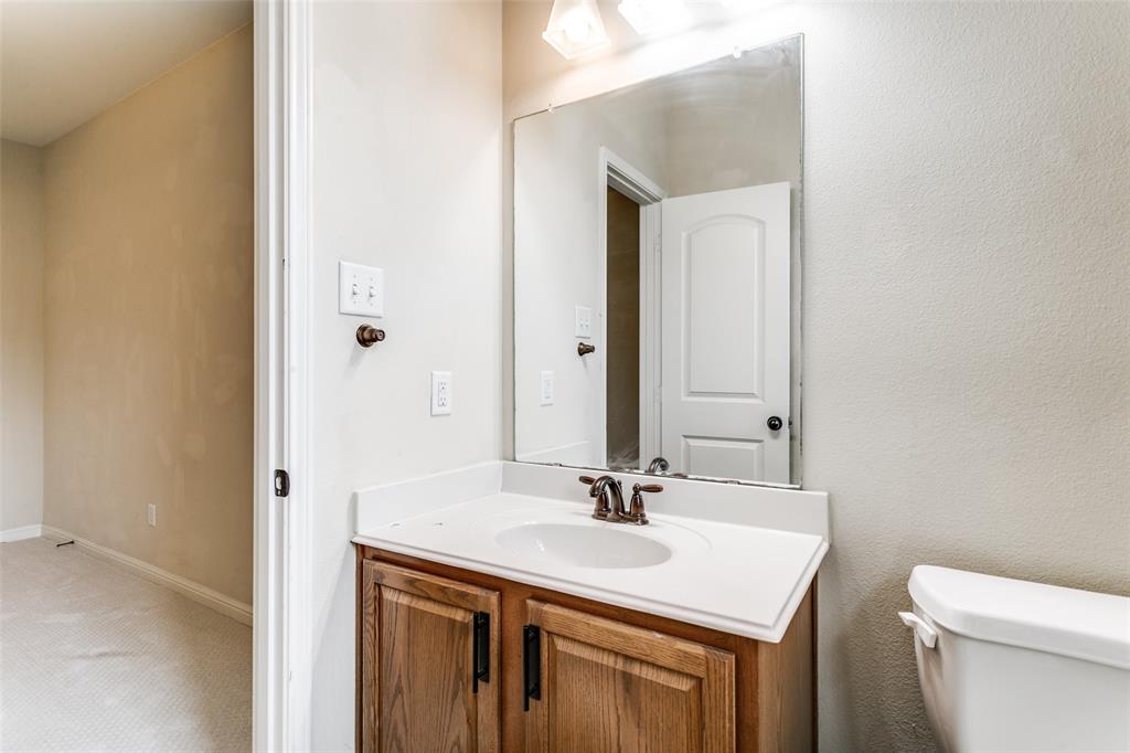 8608 Augustine Road Irving, TX 75063 - Photo 24 of 26 a bathroom with a sink and a toilet