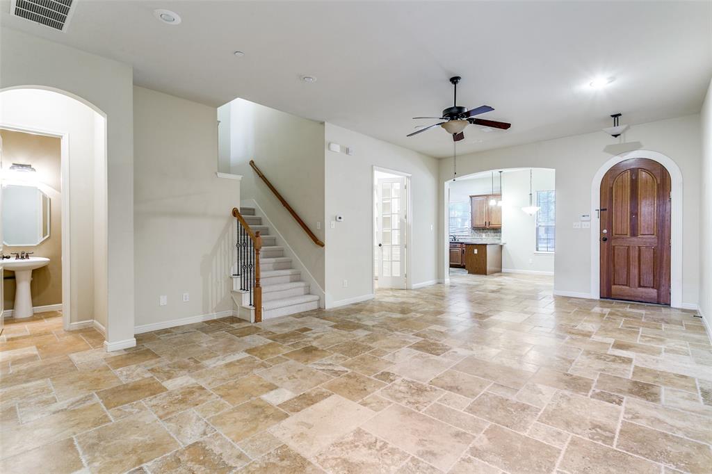 8608 Augustine Road Irving, TX 75063 - Photo 6 of 26 a view of a livingroom with a staircase and a ceiling fan