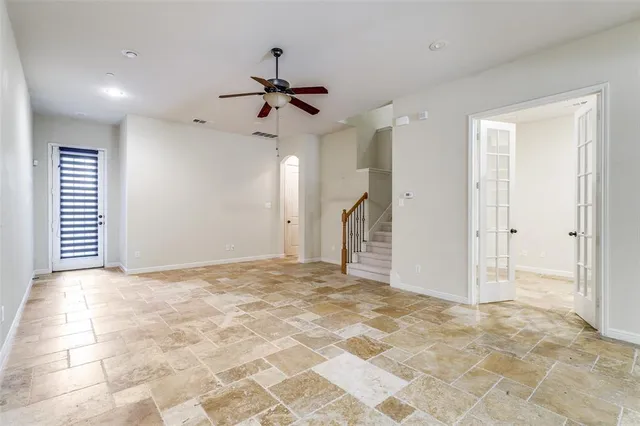 a view of a livingroom with a ceiling fan and window