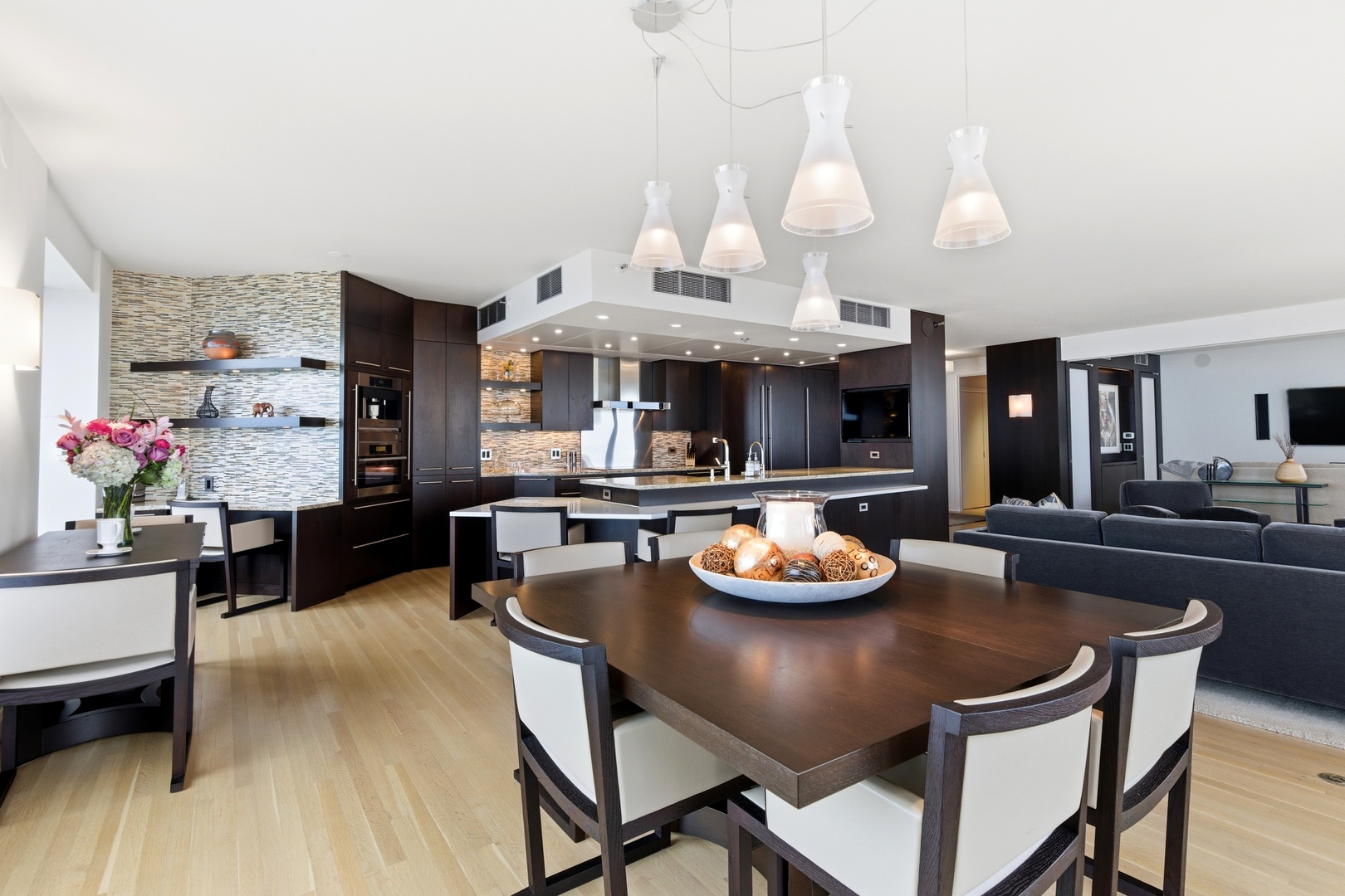 161 East Chicago Avenue, Unit 53A Chicago, IL 60611 - Photo 16 of 47 a view of a dining room with furniture a kitchen and chandelier