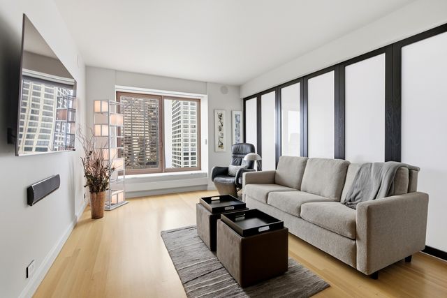 a living room with furniture and large windows