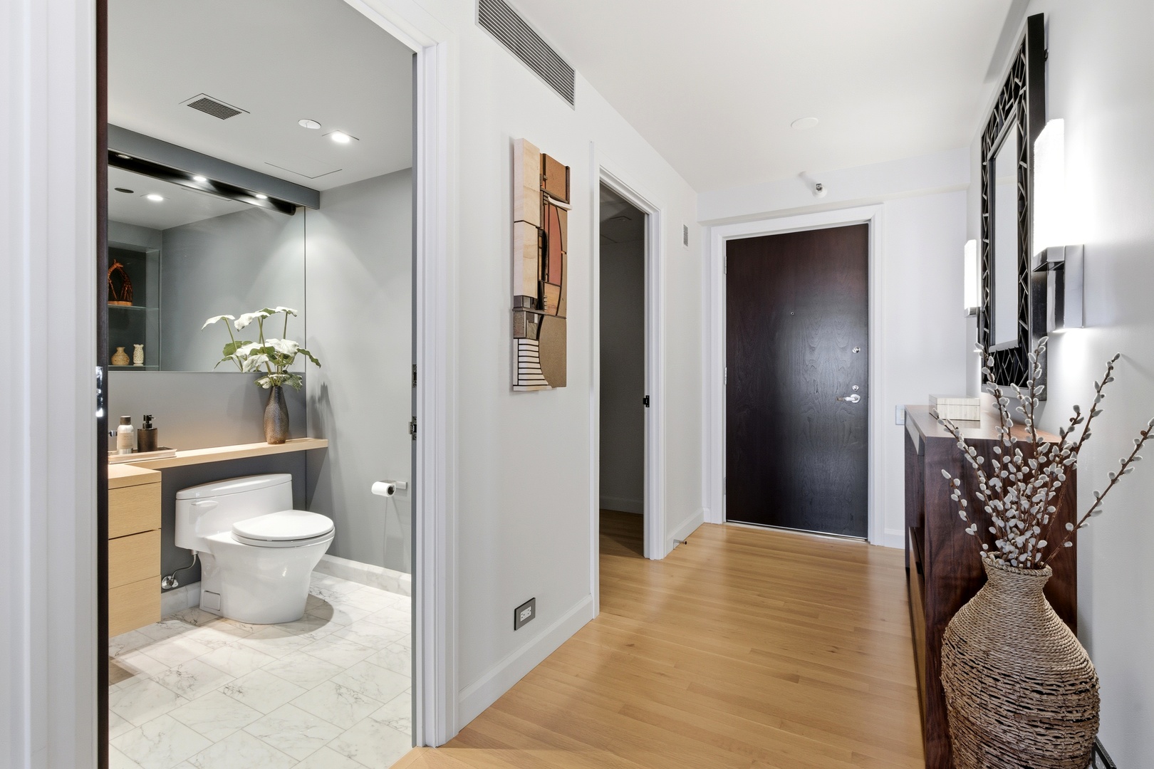 161 East Chicago Avenue, Unit 53A Chicago, IL 60611 - Photo 21 of 47 a bathroom with a toilet sink and mirror