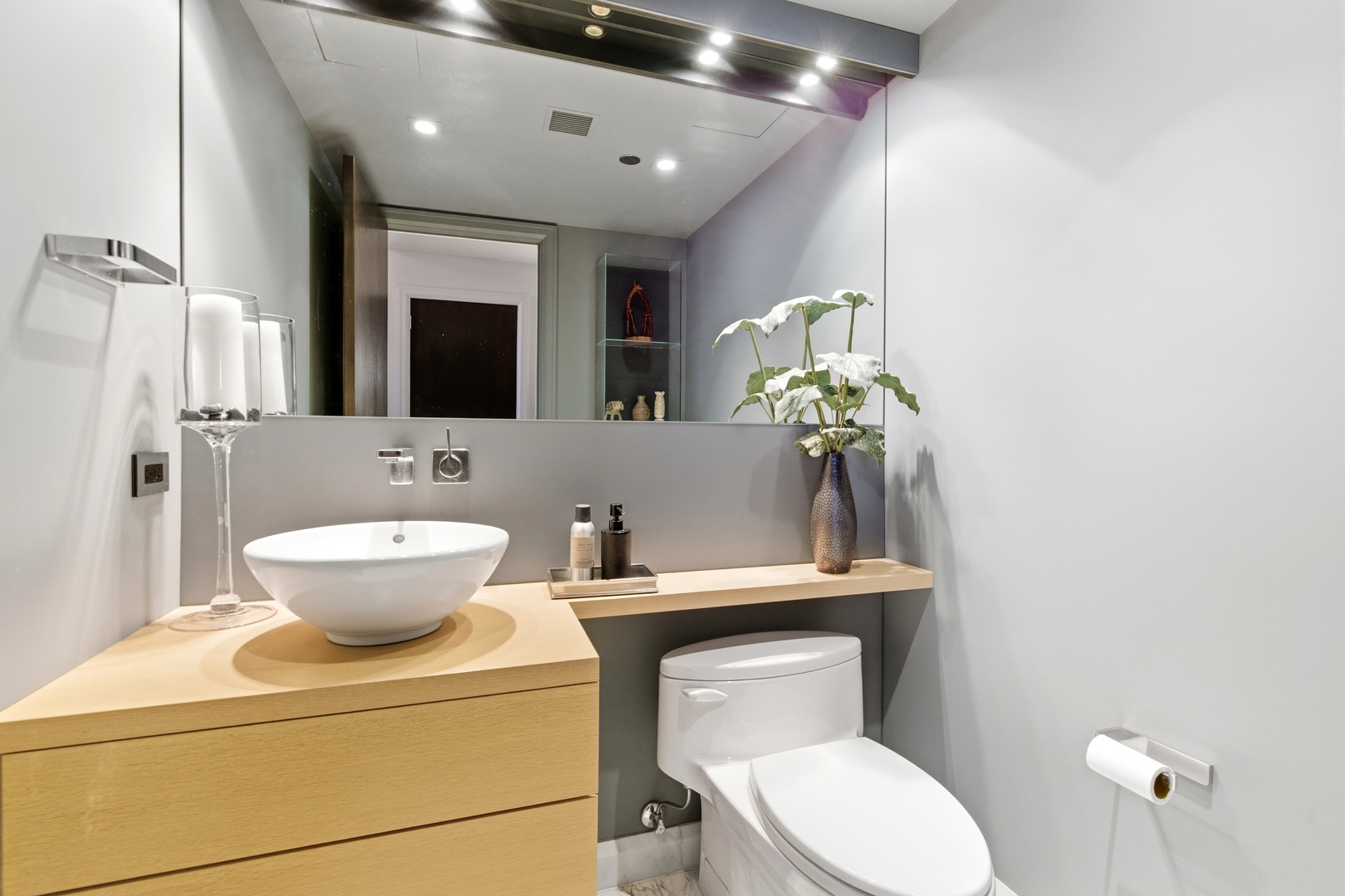 161 East Chicago Avenue, Unit 53A Chicago, IL 60611 - Photo 22 of 47 a bathroom with a toilet sink and mirror