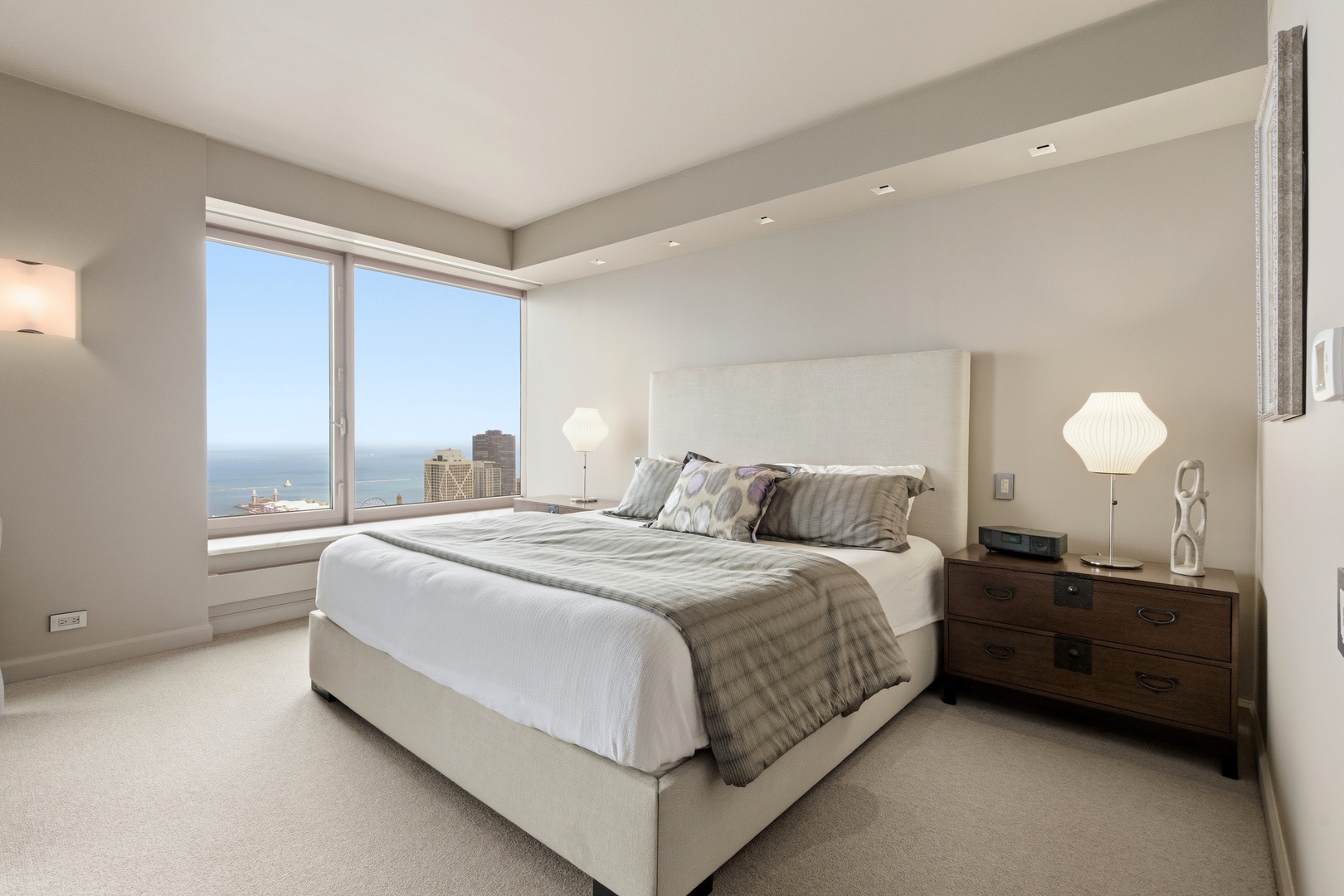 161 East Chicago Avenue, Unit 53A Chicago, IL 60611 - Photo 25 of 47 a bedroom with a bed lamp and a large window