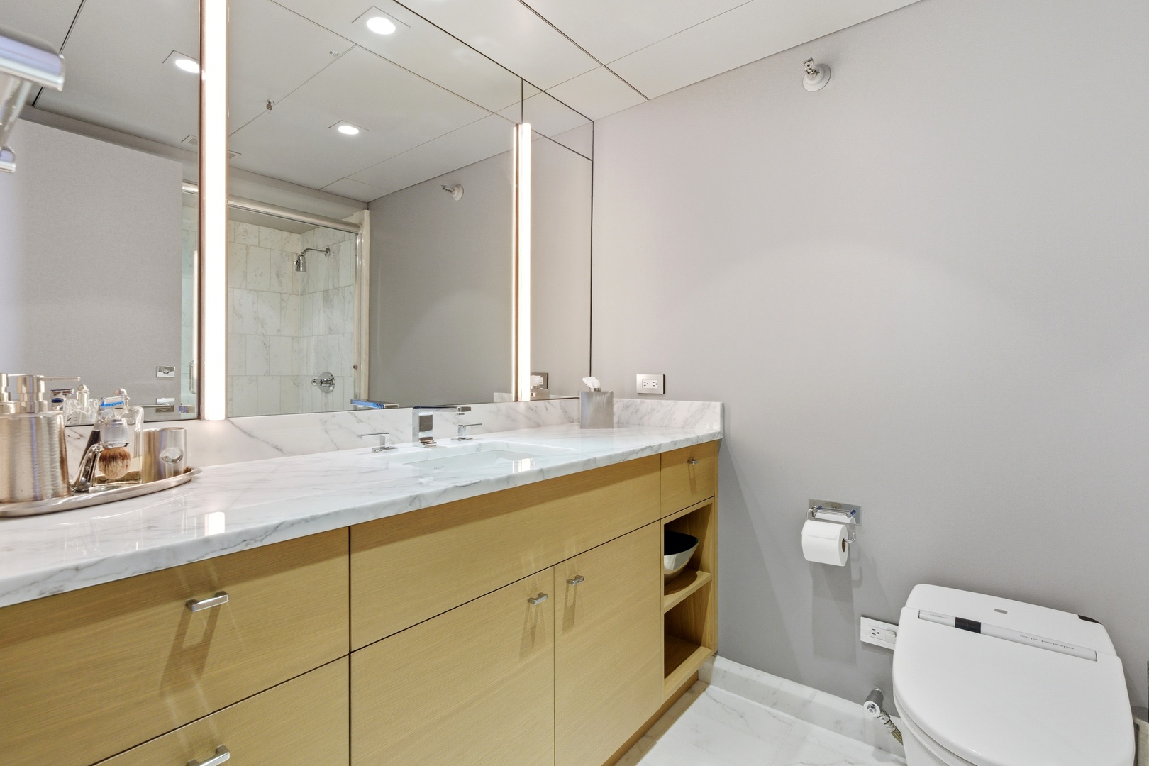 161 East Chicago Avenue, Unit 53A Chicago, IL 60611 - Photo 30 of 47 a bathroom with a granite countertop sink mirror and toilet