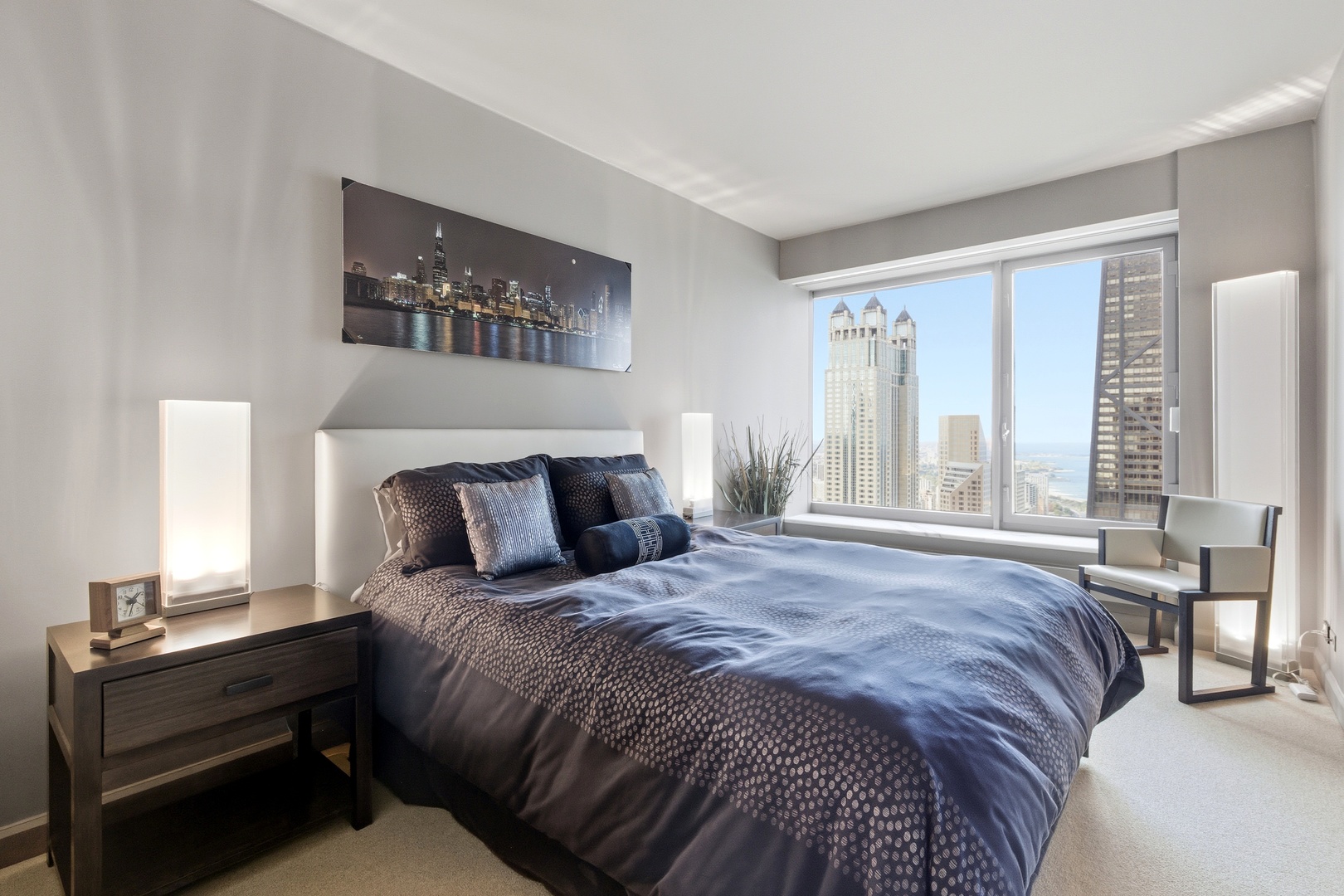 161 East Chicago Avenue, Unit 53A Chicago, IL 60611 - Photo 35 of 47 a bedroom with a bed and wooden floor