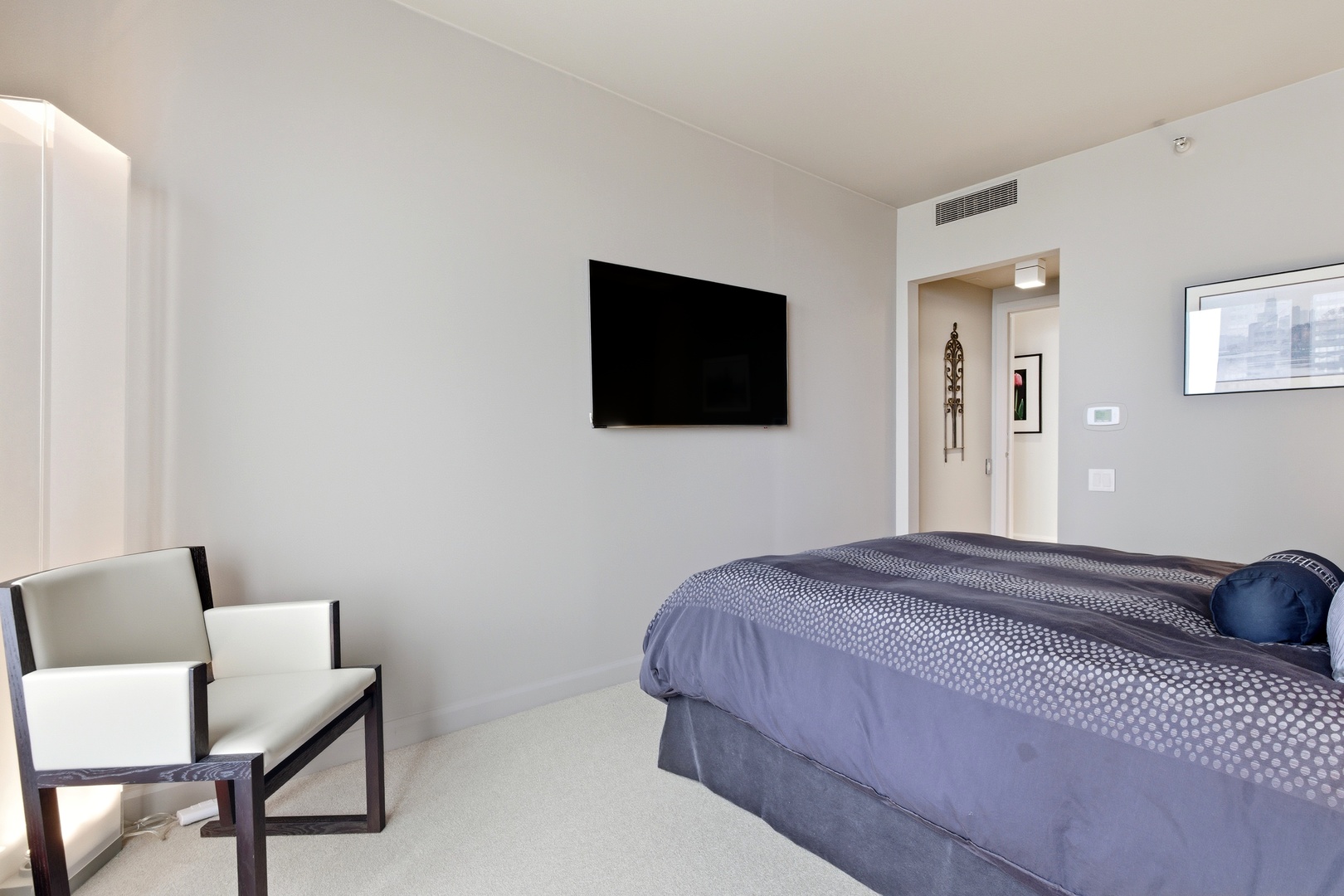 161 East Chicago Avenue, Unit 53A Chicago, IL 60611 - Photo 36 of 47 a bedroom with a bed tv and a chair