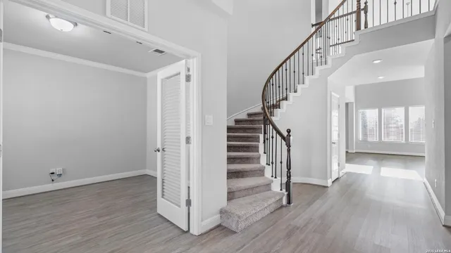 a view of entryway with wooden floor and stairs