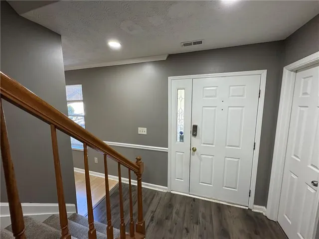 a view of an entryway with wooden floor