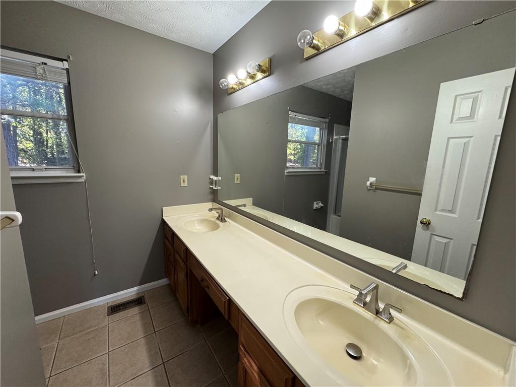 2630 Garland Way Duluth, GA 30096 - Photo 18 of 22 a bathroom with a double vanity sink and a mirror