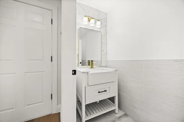a bathroom with a double vanity sink and a mirror