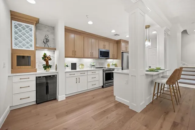 a kitchen with stainless steel appliances a refrigerator sink and microwave
