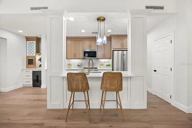 a kitchen with a refrigerator and a sink
