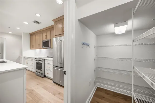 a living room with furniture and kitchen view