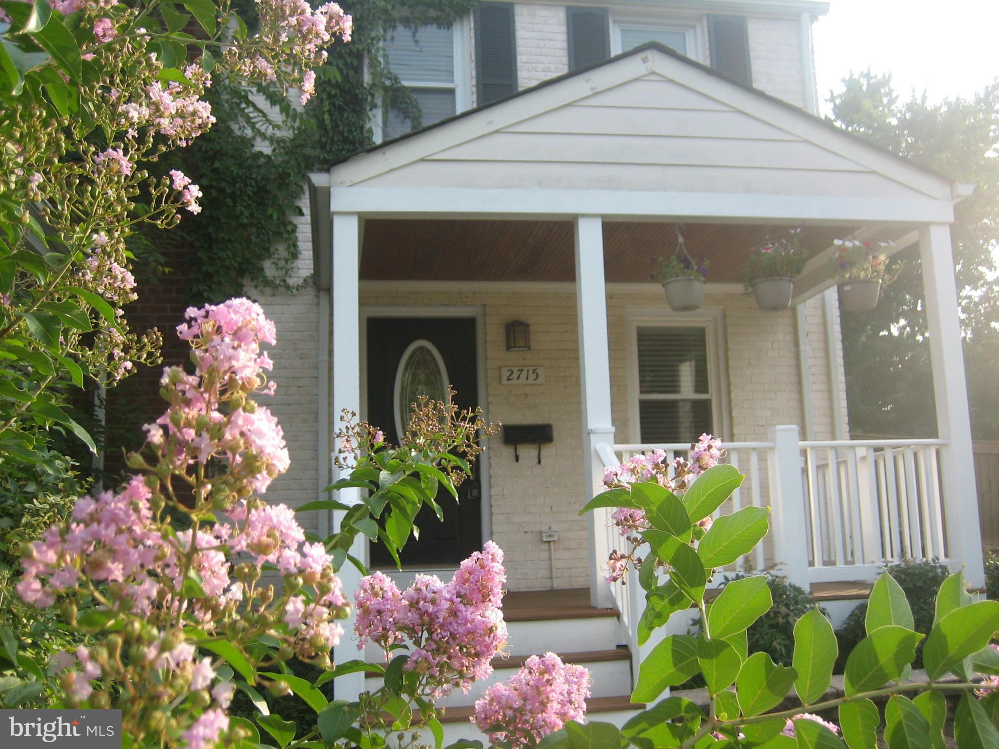 a front view of a house with a flower garden