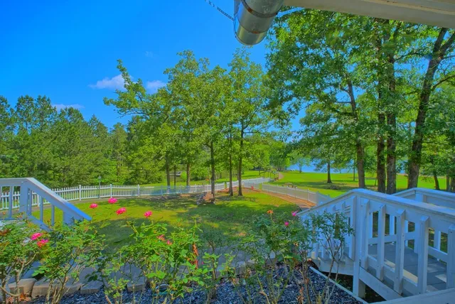 a balcony with wooden floor and outdoor seating
