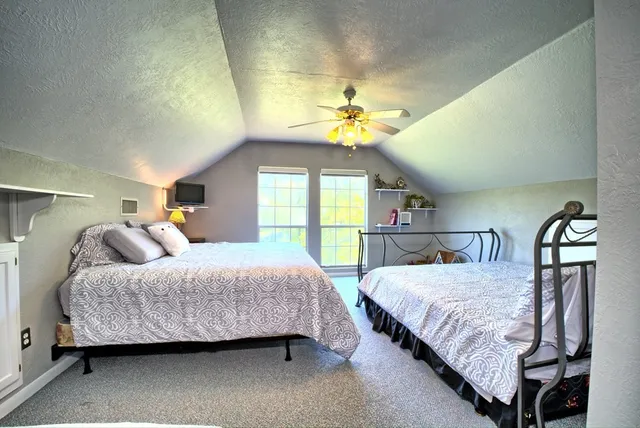 a bedroom with a bed and a lamp on desk