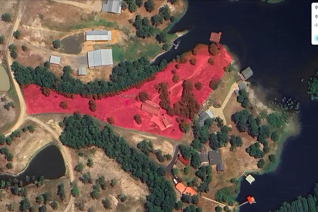 a patio with a table and chairs and potted plants