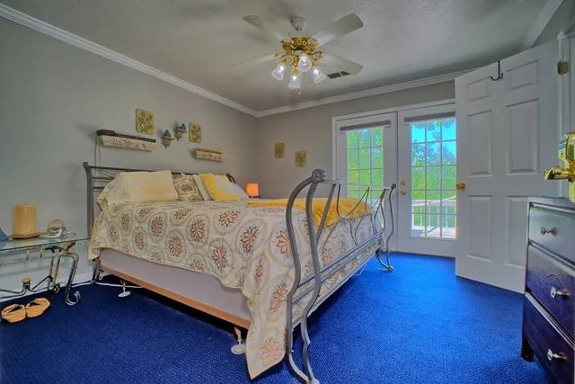 a view of a bedroom with wooden floor