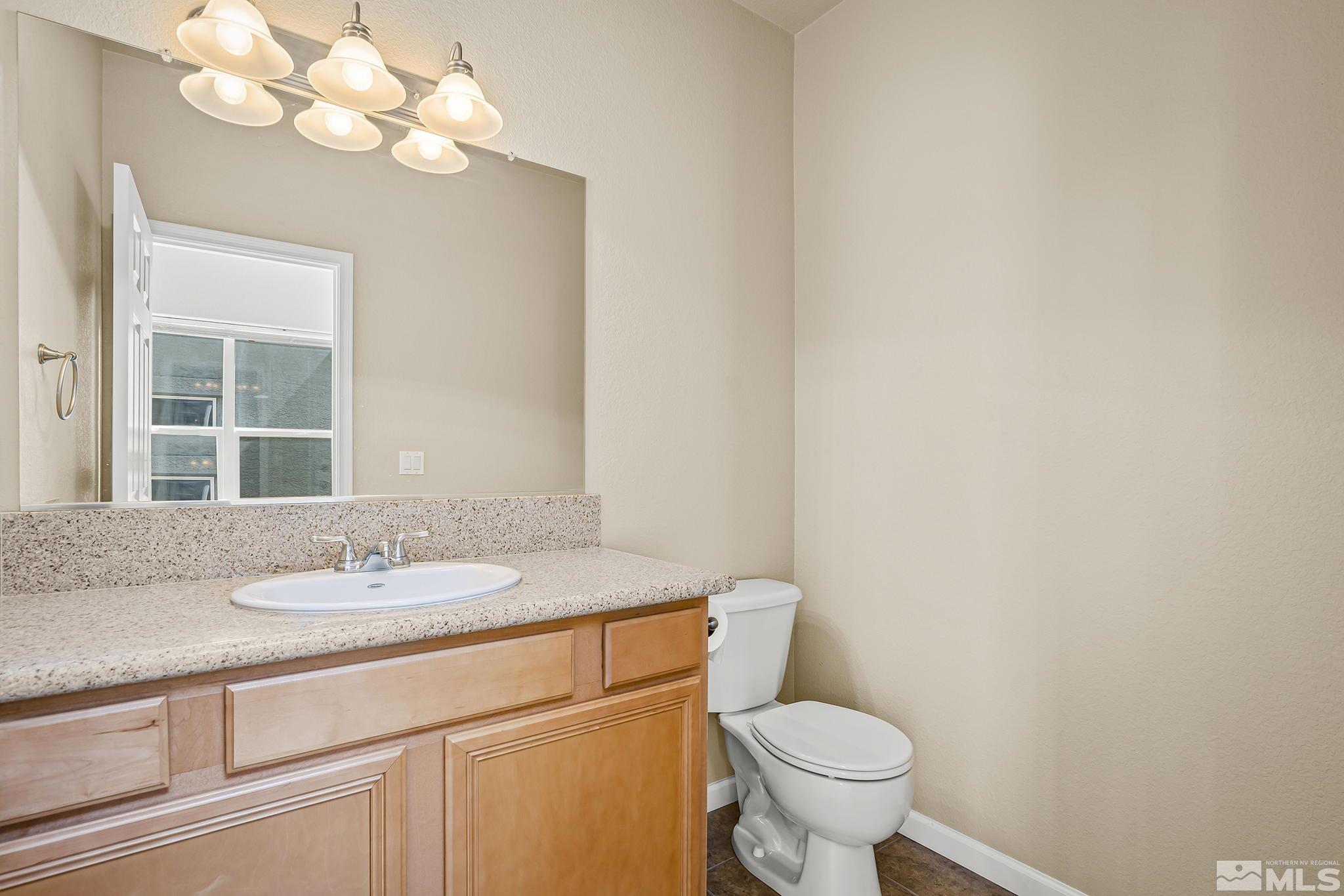 1026 Floral Ridge Way Sparks, NV 89436 - Photo 17 of 22 a bathroom with a granite countertop sink and a toilet